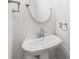 Elegant bathroom featuring a pedestal sink, a round mirror, and brushed nickel fixtures at 7301 Leharne Dr, Charlotte, NC 28270