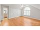 Spacious bedroom features hardwood floors, large windows, and access to an en-suite bathroom at 7301 Leharne Dr, Charlotte, NC 28270