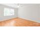 Bright bedroom with hardwood floors, double windows, and modern ceiling fan for added comfort at 7301 Leharne Dr, Charlotte, NC 28270