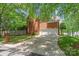 Back of brick home featuring a three car garage and wide driveway at 7301 Leharne Dr, Charlotte, NC 28270