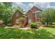 Beautiful brick home with manicured lawn, mature trees, and inviting front entrance at 7301 Leharne Dr, Charlotte, NC 28270