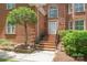 Close up of front entry steps with brick facade and manicured landscaping at 7301 Leharne Dr, Charlotte, NC 28270
