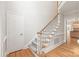 Open foyer with staircase, hardwood floors, and door to side entry at 7301 Leharne Dr, Charlotte, NC 28270
