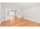 Bright living room featuring hardwood floors, white trim, and elegant glass paned french doors at 7301 Leharne Dr, Charlotte, NC 28270