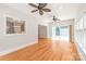 Open-concept living room with hardwood floors, ceiling fans, and sliding glass doors provides great flow and natural light at 7301 Leharne Dr, Charlotte, NC 28270