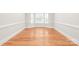 Cozy living room featuring hardwood floors, bay windows, and detailed molding, offers a charming and comfortable space at 7301 Leharne Dr, Charlotte, NC 28270
