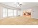 Bright sunroom featuring carpet, a ceiling fan, and bay windows providing ample natural light at 7301 Leharne Dr, Charlotte, NC 28270