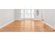 Bright and airy living room with hardwood floors, large windows, and a white door, creates a welcoming atmosphere at 7301 Leharne Dr, Charlotte, NC 28270