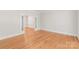 Living room with hardwood floors, white trim and open access to other rooms at 7301 Leharne Dr, Charlotte, NC 28270