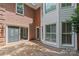 Wooden patio with sliding door and brick exterior, perfect for outdoor entertaining and enjoying the natural surroundings at 7301 Leharne Dr, Charlotte, NC 28270