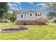 Rear exterior view of home with a fire pit and a small wood deck at 810 Maplewood Ave, Kannapolis, NC 28081