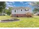 View of the backyard with a fire pit and wooden steps to the house at 810 Maplewood Ave, Kannapolis, NC 28081