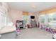Spacious pink bedroom with a toy kitchen and views to the outside at 810 Maplewood Ave, Kannapolis, NC 28081