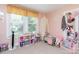 Cozy pink bedroom featuring a bright window and built-in storage shelves at 810 Maplewood Ave, Kannapolis, NC 28081