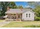 Charming single-story home with a cozy front porch, swing and well-manicured landscaping at 810 Maplewood Ave, Kannapolis, NC 28081