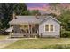 Charming single-story home with a cozy front porch, swing and well-manicured landscaping at 810 Maplewood Ave, Kannapolis, NC 28081