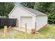 Exterior view of detached garage with a white garage door and siding at 810 Maplewood Ave, Kannapolis, NC 28081