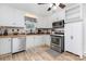 Well-lit kitchen with butcher block countertops, stainless steel appliances, and white cabinets at 810 Maplewood Ave, Kannapolis, NC 28081