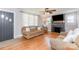 Bright living room featuring a fireplace, hardwood floors, and a ceiling fan at 810 Maplewood Ave, Kannapolis, NC 28081