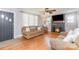 Bright living room featuring a fireplace, hardwood floors, and a ceiling fan at 810 Maplewood Ave, Kannapolis, NC 28081