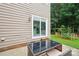 Backyard patio area with outdoor furniture, sliding glass door, and a garden bed at 8618 Sam Dee Rd, Charlotte, NC 28215