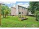 Spacious backyard with a well-maintained lawn, garden, and fenced perimeter, offering privacy at 8618 Sam Dee Rd, Charlotte, NC 28215