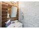 Charming bathroom with wood accent wall, white brick wall, and stylish vanity at 8618 Sam Dee Rd, Charlotte, NC 28215
