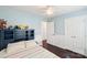 Bright bedroom with light blue walls, hardwood floors, and a built-in bookshelf headboard at 8618 Sam Dee Rd, Charlotte, NC 28215