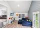 Bright bonus room with blue accent wall and comfortable seating area at 8618 Sam Dee Rd, Charlotte, NC 28215