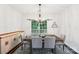 Bright dining room featuring a chandelier, large window, and stylish furnishings at 8618 Sam Dee Rd, Charlotte, NC 28215