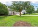 Charming two-story home with light brown siding, red shutters, well-manicured lawn, and attached two-car garage at 8618 Sam Dee Rd, Charlotte, NC 28215