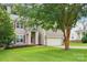 Charming two-story home with light brown siding, red shutters, well-manicured lawn, and attached two-car garage at 8618 Sam Dee Rd, Charlotte, NC 28215
