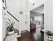 Bright foyer with hardwood floors, white walls, staircase, and views into the living room at 8618 Sam Dee Rd, Charlotte, NC 28215