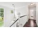 Bright hallway with dark hardwood floors, and decorative lighting fixture at 8618 Sam Dee Rd, Charlotte, NC 28215