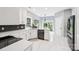 Bright kitchen with white cabinets, modern appliances, and a stylish backsplash at 8618 Sam Dee Rd, Charlotte, NC 28215