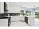 Modern kitchen with white cabinets, updated appliances, and plenty of counter space at 8618 Sam Dee Rd, Charlotte, NC 28215