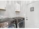 Functional laundry room with modern LG washer and dryer units and storage cabinets at 8618 Sam Dee Rd, Charlotte, NC 28215