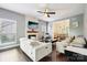Open living room with a fireplace, hardwood floors, and an adjacent dining area at 8618 Sam Dee Rd, Charlotte, NC 28215