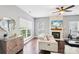 Inviting living room featuring a fireplace, hardwood floors, and a stylish ceiling fan at 8618 Sam Dee Rd, Charlotte, NC 28215