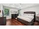 Spacious main bedroom with tray ceiling, ceiling fan, hardwood floors and natural light at 8618 Sam Dee Rd, Charlotte, NC 28215