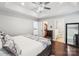 Bright main bedroom featuring hardwood floors, ceiling fan and ensuite bathroom at 8618 Sam Dee Rd, Charlotte, NC 28215