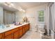 Bright bathroom boasting double sinks, spacious vanity, and a large mirror, perfect for a Gathering at 8909 Savannah Rd, Harrisburg, NC 28075