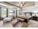 Spacious primary bedroom featuring a trey ceiling, neutral paint, chaise lounge and stylish rug at 8909 Savannah Rd, Harrisburg, NC 28075