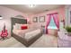 This bedroom includes pink decor and a large bed frame, perfect for a or teenager at 8909 Savannah Rd, Harrisburg, NC 28075