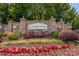 Charming stone entrance sign for Litchfield Village with colorful flowers and landscaping at 8909 Savannah Rd, Harrisburg, NC 28075