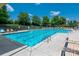 Refreshing community pool with clear blue water, surrounded by lounge chairs, perfect for summer relaxation at 8909 Savannah Rd, Harrisburg, NC 28075