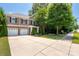 Beautiful home with a well-maintained lawn, mature trees, and an inviting front entrance at 8909 Savannah Rd, Harrisburg, NC 28075