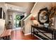 Warm foyer featuring hardwood floors, a staircase, and decorative accents at 8909 Savannah Rd, Harrisburg, NC 28075