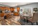 Eat-in kitchen with wooden cabinets, granite countertops, and adjacent dining area with a round table at 8909 Savannah Rd, Harrisburg, NC 28075