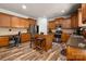 Spacious kitchen featuring wood cabinets, an island with seating, stainless steel appliances, and granite countertops at 8909 Savannah Rd, Harrisburg, NC 28075
